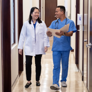doctor and assistant walking down the hallway of stem cell clinic