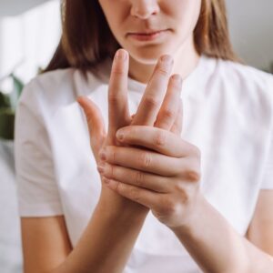 Woman holding hand in pain