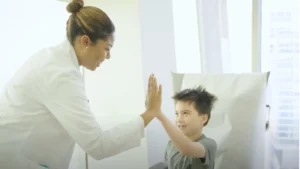 Luciano high-fiving his doctor at Stem Cell Institute Panama