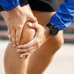 Man holding knee in pain
