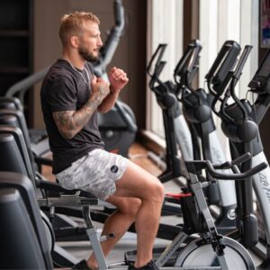 TJ Dillashaw using an exercise bike at Stem Cell Institute's gym in between treatments