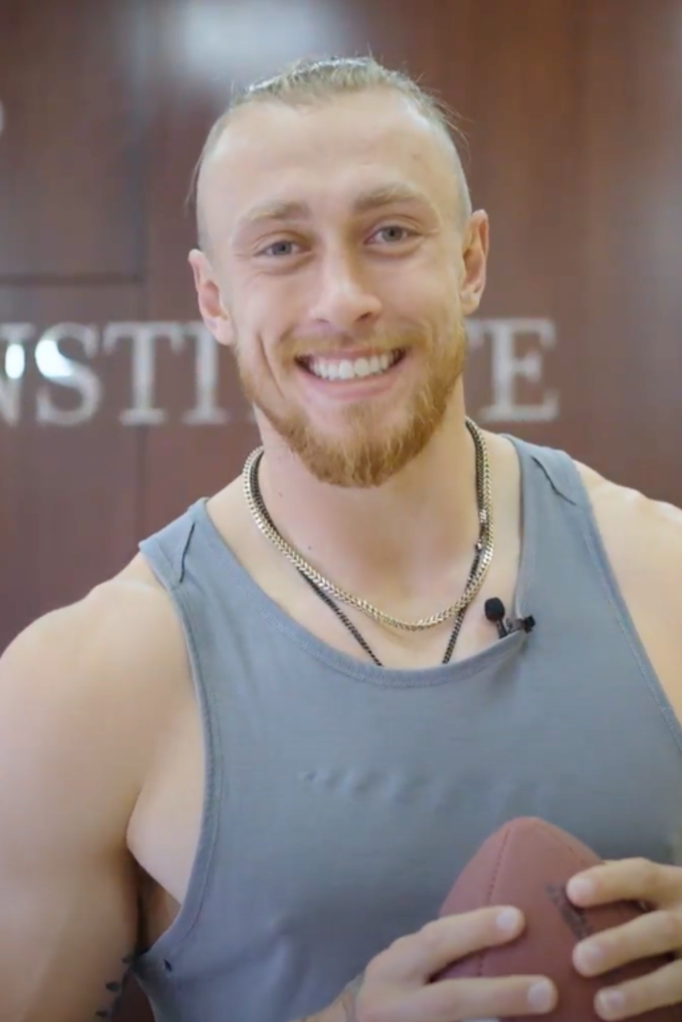 George Kittle smiling with a football at Stem Cell Institute Panama