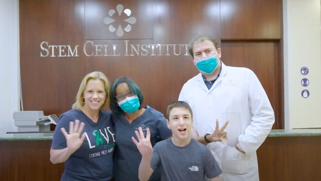 Owen and his mother with the Stem Cell Institute staff