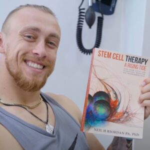 George Kittle holding Stem Cell Therapy: A Rising Tide: How Stem Cells Are Disrupting Medicine and Transforming Lives