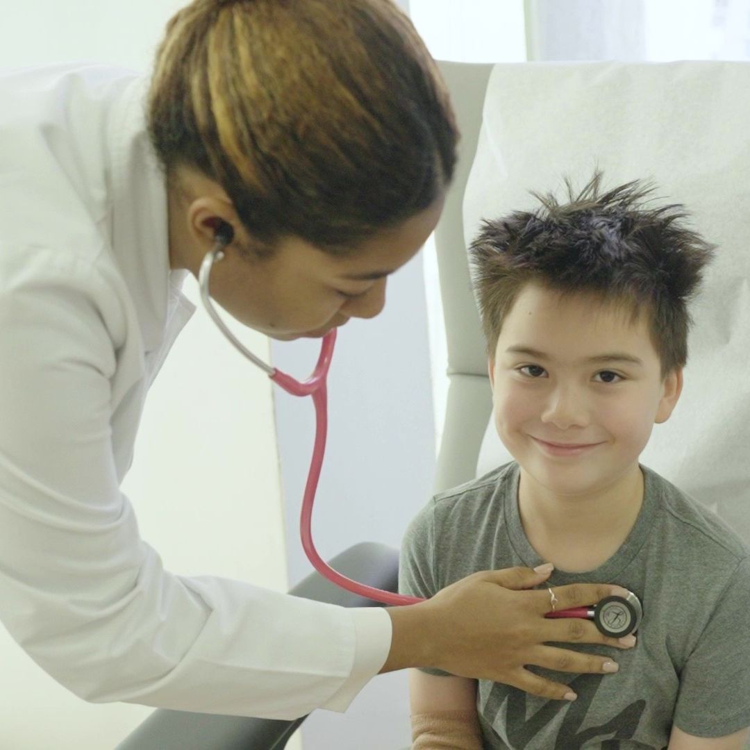 stem cell specialist checking a young male patient's heartbeat