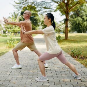 wellness and longevity benefits of stem cells couple practicing tai chi outdoors in the morning