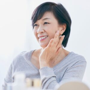 Stem Cell Therapy for Aging older woman touching her face and smiling