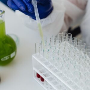 Scientist putting liquid in a test tube using an eye dropper