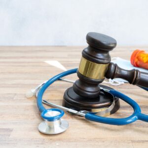 law gavel with stethoscope, masks, and pills